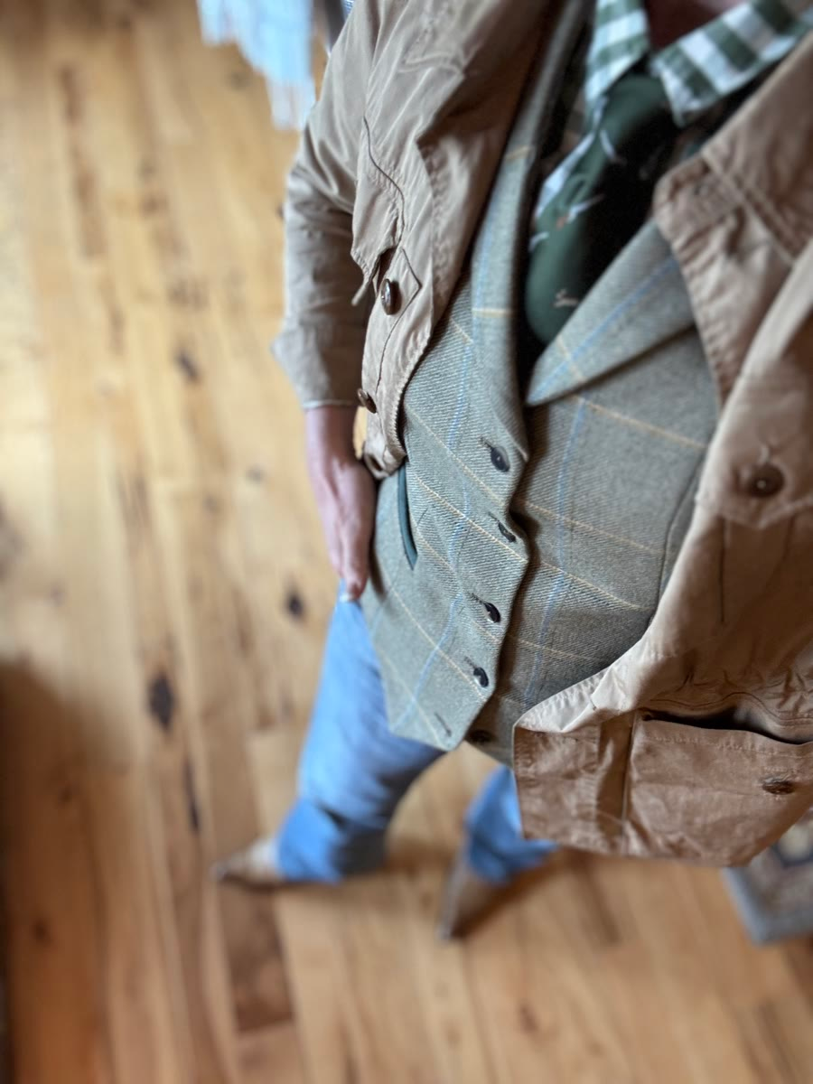 Full ladies field fashion look with tweed vest, barn coat, jeans and boots