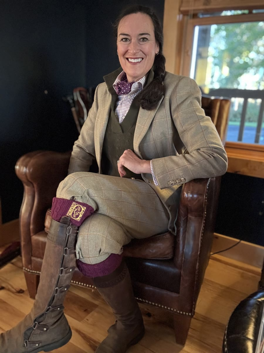 Driven shooting outfit with a tweed jacket, breeks, purple shooting socks and tall boots
