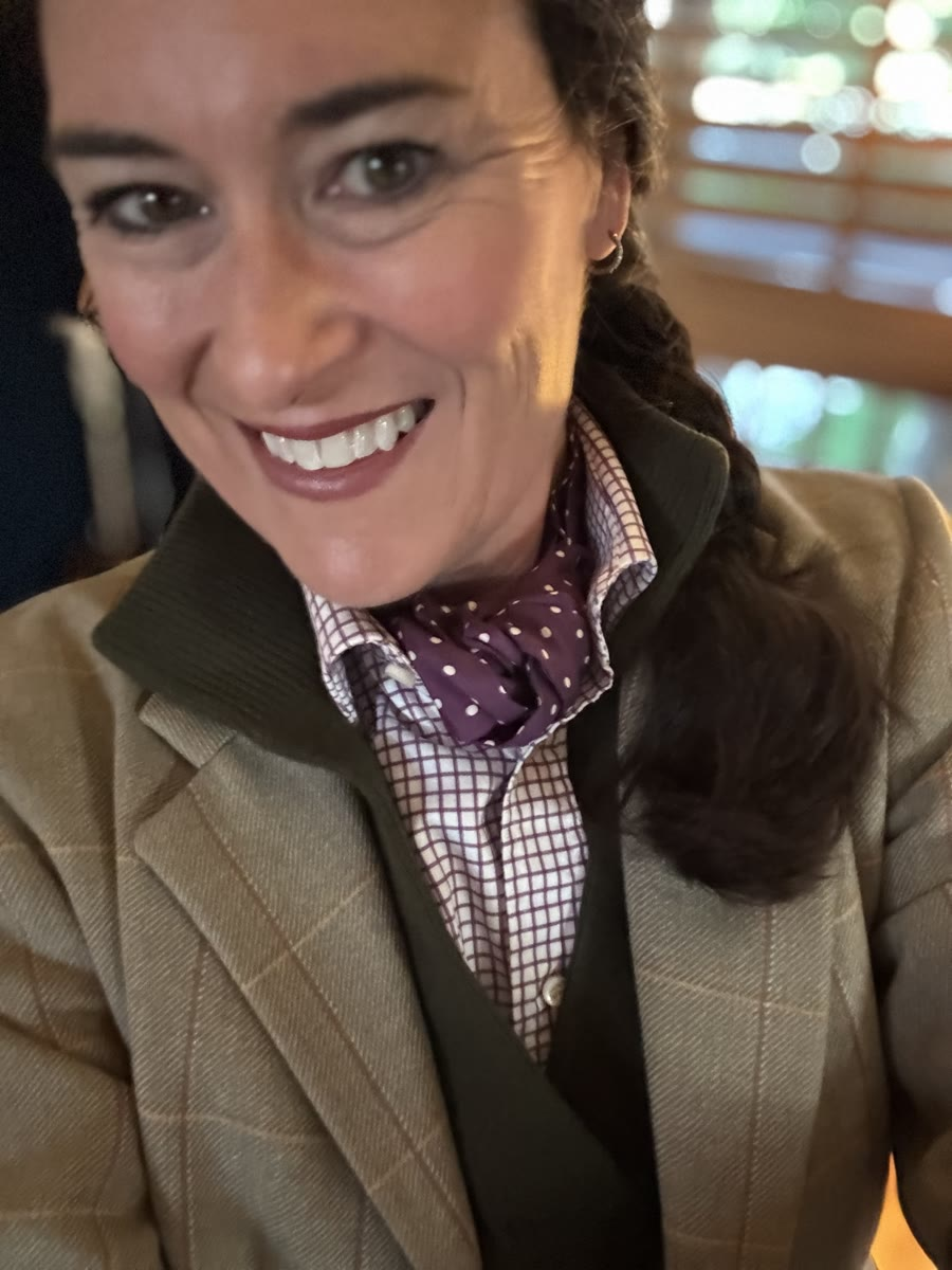 Tweed jacket with an olive sweater vest, check shirt and purple polka-dot neckerchief